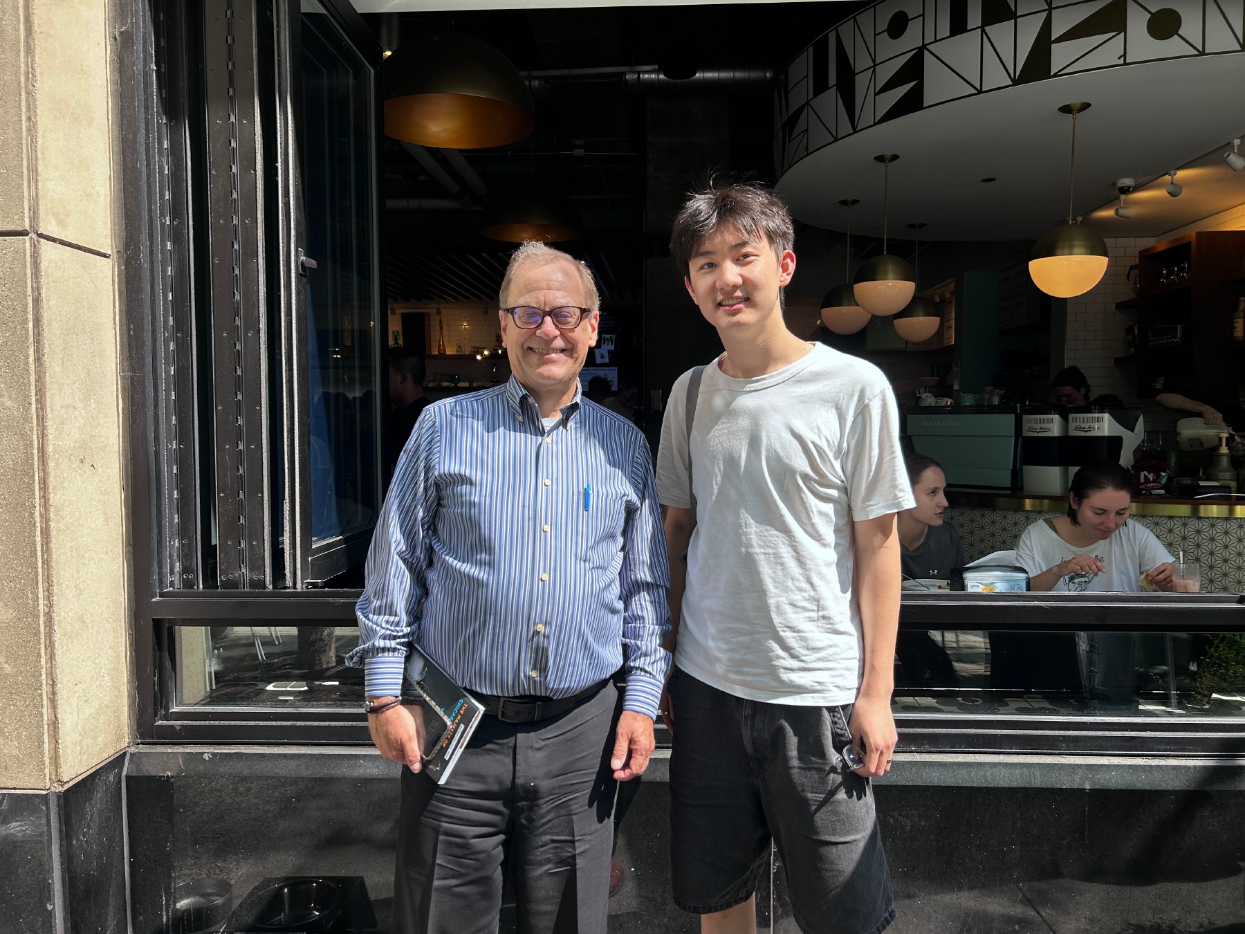 Robert M. Marovich and the interviewer outside a cafe